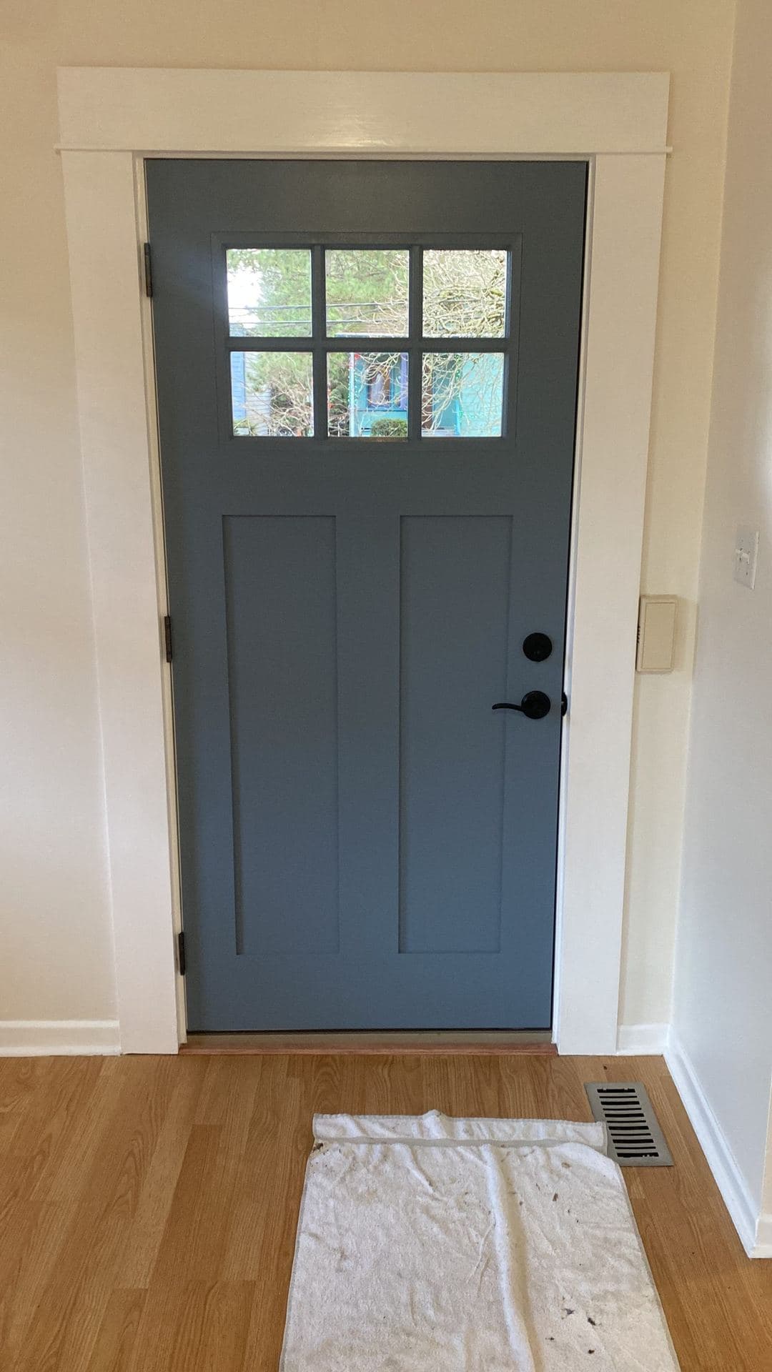 Interior view of a finished craftsman entry door with new white casing
