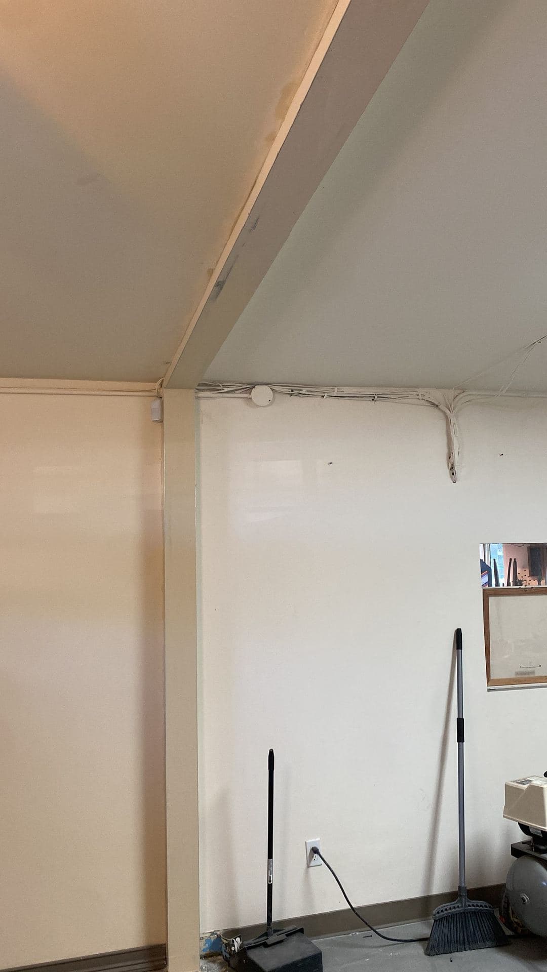 Finished room with an angled ceiling and smooth painted walls